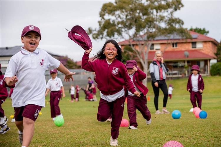 A group of students running in a carnival on the oval