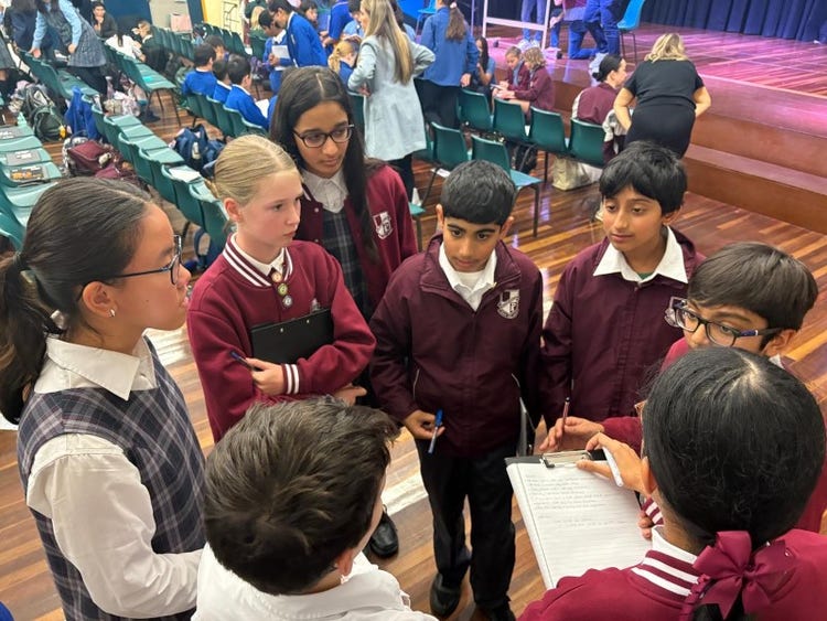 Students standing together to discuss their debating topic