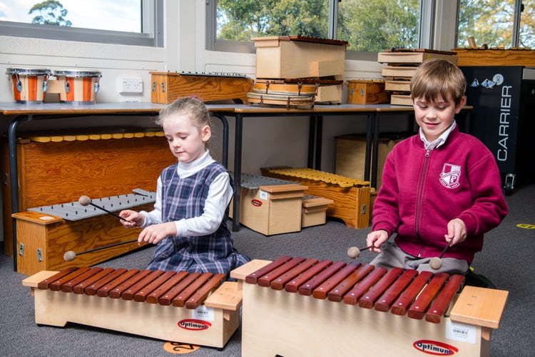 Two students playing the Xylophone