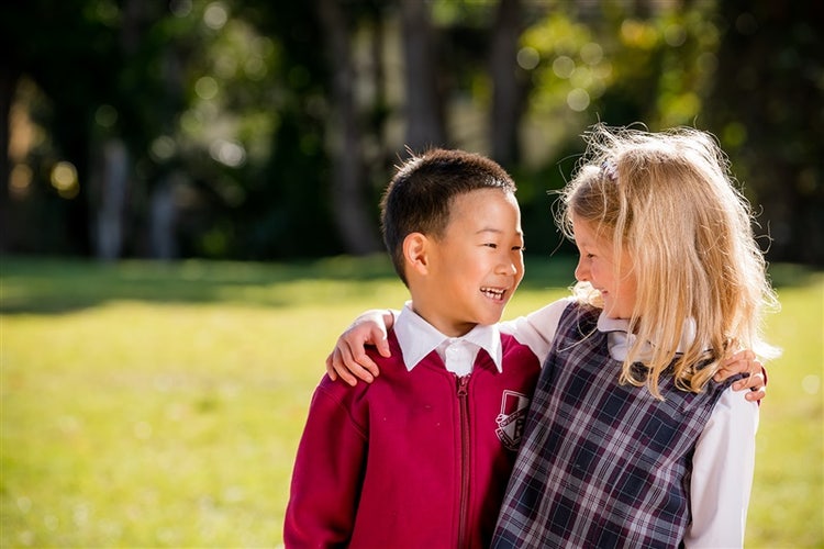 Two students smiling at each-other
