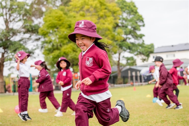 Students running on the oval