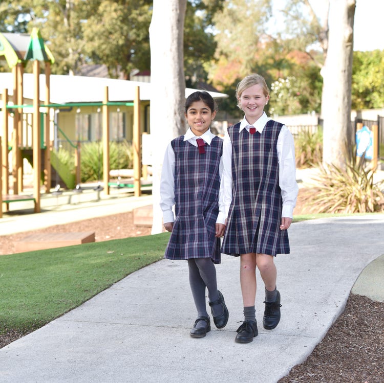 Two students walking together in the playground